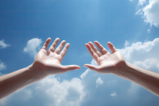 Close up of human hands against blue sky with white clouds background