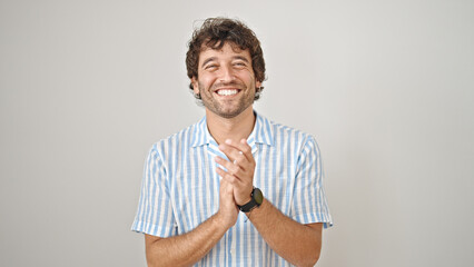 Young hispanic man smiling confident clapping hands over isolated white background