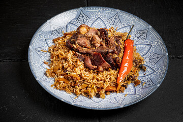 pilaf with veal on black background