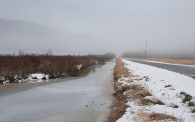 Looking down a ditch along Rannie Road near the Grant Narrows Regional Park and Pitt River Dike...
