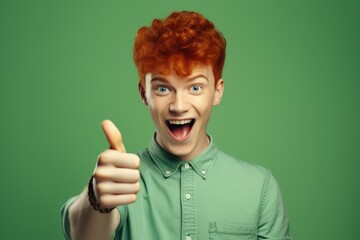 A man with red hair showing his approval with a thumbs up gesture. Perfect for expressing positivity and agreement in various contexts