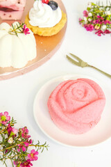 Sweets on a plate - on the table. Rose-shaped yogurt dessert.