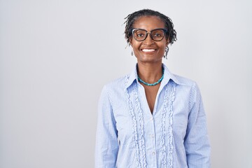 African woman with dreadlocks standing over white background wearing glasses with a happy and cool...