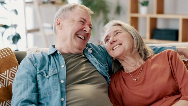 Laughing, love and senior couple hug on a sofa with funny, conversation or bonding at home together. Marriage, retirement or happy old people in a living room with silly joke, support and gratitude