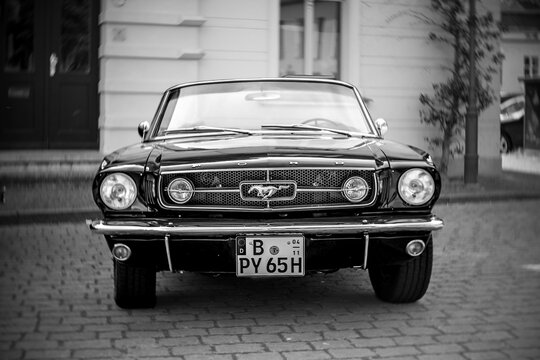WERDER (HAVEL), GERMANY - MAY 20, 2023: The muscle car Ford Mustang Convertible, 1965. Swirl bokeh, art lens. Black and white. Oldtimer - Festival Werder Classics 2023
