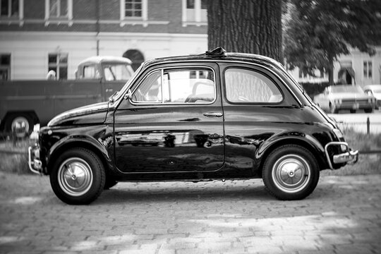 WERDER (HAVEL), GERMANY - MAY 20, 2023: The city car Fiat 500. Swirl bokeh, art lens. Black and white. Oldtimer - Festival Werder Classics 2023