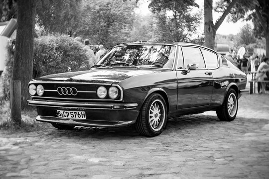 WERDER (HAVEL), GERMANY - MAY 20, 2023: The mid-size car Audi 100 Coupe S, 1976. Swirl bokeh, art lens. Black and white. Oldtimer - Festival Werder Classics 2023
