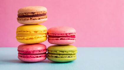 Fototapeta na wymiar Macaroons stacked on pink background, copyspace on a side