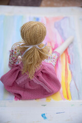 toddler doll on the colorful background, vintage style, selective focus