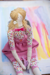 toddler doll on the colorful background, vintage style, selective focus