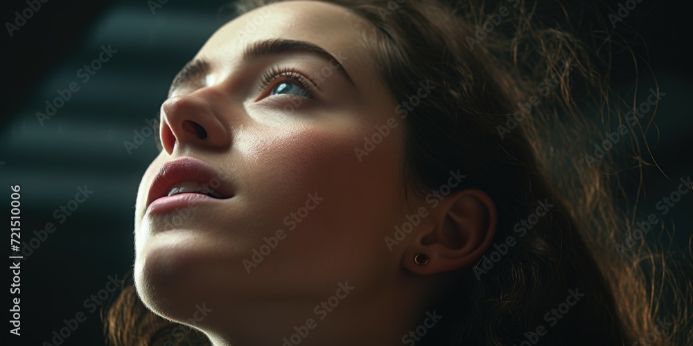 Poster a close up image of a woman looking up. suitable for various applications