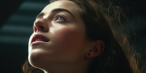 Fototapeta premium A close up image of a woman looking up. Suitable for various applications
