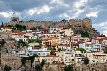 Fototapeta na wymiar Beautiful, colorful old houses at the old part of Kavala town, with the local medieval castle on top of hill above the old town.