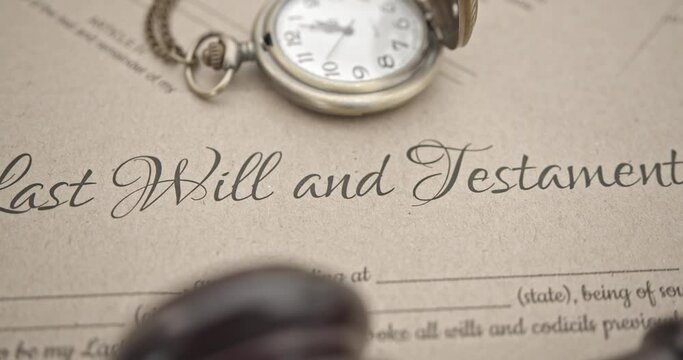 Last will and testament, legacy, inheritance or death tax concept : A judge gavel, old retro watch on a last will and testament legal document form, depicting the intersection of time and justice.
