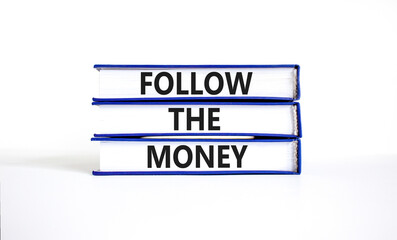 Follow the money symbol. Concept words Follow the money on beautiful books. Beautiful white table white background. Business and follow the money concept. Copy space.