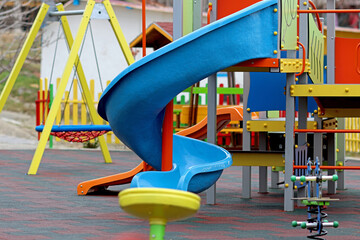 Children's playground in an urban environment. Children's games outdoors in an organized and safe space. Slide.