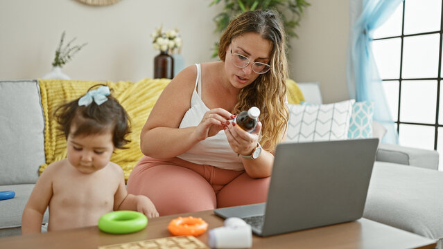 A loving mother and child seeking medical advice from the comfort of their living room, sitting together on the sofa, browsing health information on their laptop at home