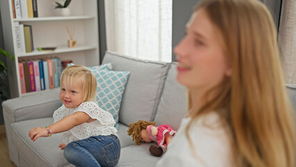 Relaxed caucasian mother and her little girl confidently sharing smiles indoors, comfortably...
