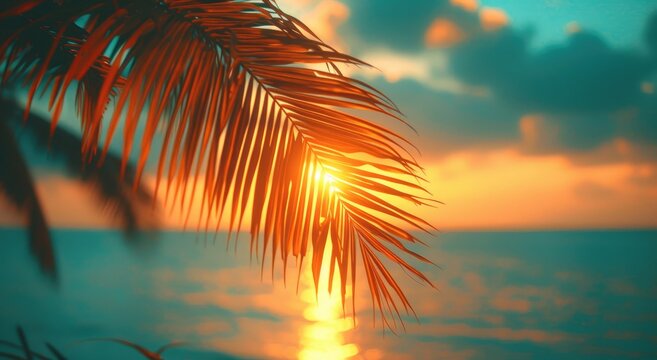 The majestic palm tree, silhouetted against the vibrant sunset sky, creates a serene tropical scene that evokes feelings of tranquility and bliss by the shimmering ocean waters