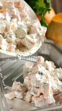 Place the raw pumpkin pieces with the garlic and herb cream sauce in a bowl onto a foil baking tray. Cooking pumpkin stew, vegetarian casserole from Cucurbita moschata. Vertical