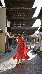 Spinning around in joy, a beautiful hispanic woman unveils her dress on the ancient streets of...