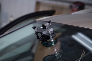Fototapeta na wymiar Windshield repair. repair of a chip on the windshield of a car.