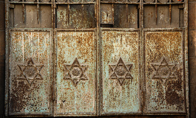 Fragment of old rusty metal doors of a historical jerusalem building with Stars of David