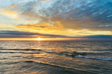 Sunset on Baltic Sea white bright golden orange color and calm sea
- 721523611