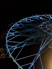 Ferris wheel glowing at night 