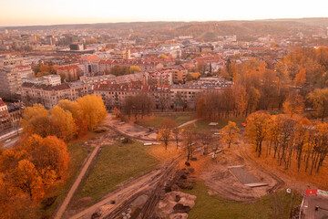 Fototapeta premium Drone photography of public park in city downtown being renovated during autumn sunset