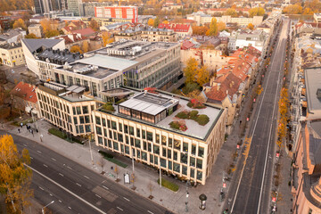 Drone photography of a restaurant on a rooftop in city downtown district during autumn sunset