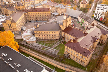 Drone photography of abandoned and old prison in a city during autumn sunset