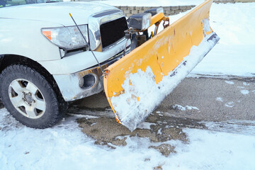 truck with snowplow installed in the parking lots