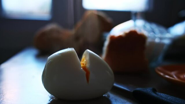 Cooked and boiled eggs are cut in half in macro shot
