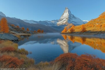 Obraz premium Scenic view of the Matterhorn and autumn foliage reflected in the Riffelsee lake, Switzerland
