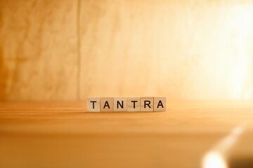 Tantra, graphic resource with wooden letters and golden light