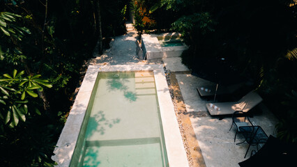 aerial view with a drone above swimming pool in the jungle of mexico
