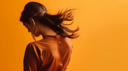 A medium-sized picture of a woman bending back with an orange background. - obrazy, fototapety, plakaty