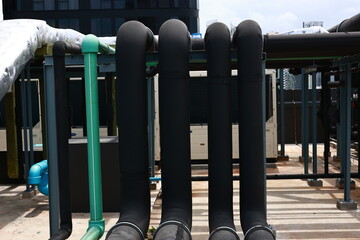 Close-up water piping and cooling piping system on rooftop of building, building engineering system