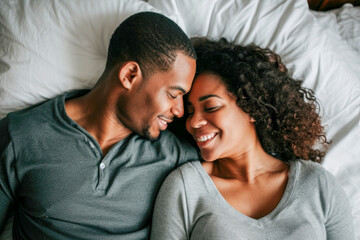 Smiling couple on bed