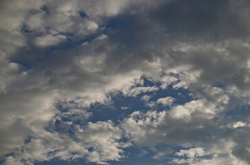 Background of rainy fluffy clouds floating on a bright blue sky, Sofia, Bulgaria  
