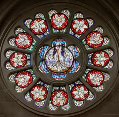  BERN, SWITZERLAND - JUNY 27, 2022: The Pelican as symbolo of offer of Jesus on the stained glass rosette in the church Dreifaltigkeitskirche by A. Schweri (1938). © Renáta Sedmáková