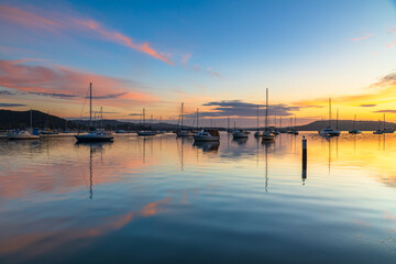 Sunrise, boats and reflections on the water