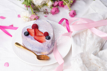 Trendy bento cake in love heart shape form on a light breakfast in bed background. Cake for Valentine's Day, Mother's Day, or Birthday, Love Forever Message, Romantic Bento Cake for Two