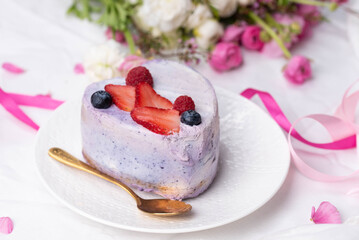 Trendy bento cake in love heart shape form on a light breakfast in bed background. Cake for Valentine's Day, Mother's Day, or Birthday, Love Forever Message, Romantic Bento Cake for Two