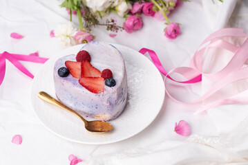 Trendy bento cake in love heart shape form on a light breakfast in bed background. Cake for Valentine's Day, Mother's Day, or Birthday, Love Forever Message, Romantic Bento Cake for Two