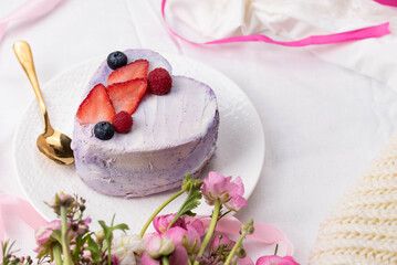 Trendy bento cake in love heart shape form on a light breakfast in bed background. Cake for Valentine's Day, Mother's Day, or Birthday, Love Forever Message, Romantic Bento Cake for Two