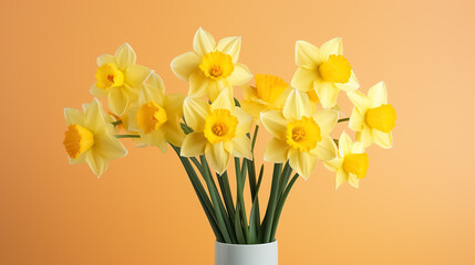Spring bouquet of yellow daffodils on an isolated yellow background with copyspace, pastel colors.