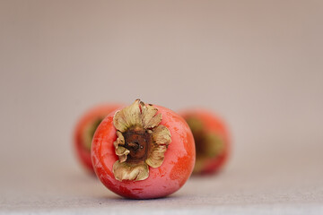 Persimmon, beautiful and ripe single piece of fruit.