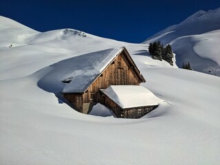Snowy alp in the Glarus mountains. Beautiful mountain landscape. Hut discovered on a ski tour. High...
